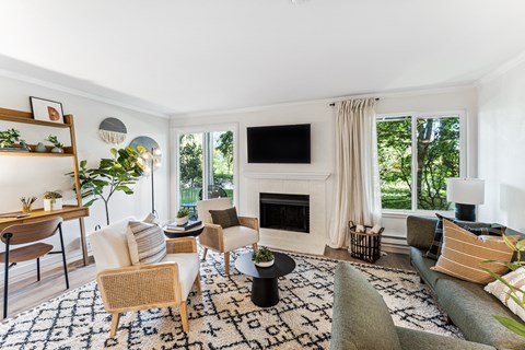 a living room with a couch and chairs and a fireplace
